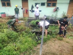 Babinsa Koramil 11/Tambusai Bantu Warga Bersihkan Drainase